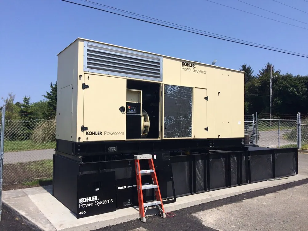 Large Kohler standby generator on a concrete pad with a ladder beside it
